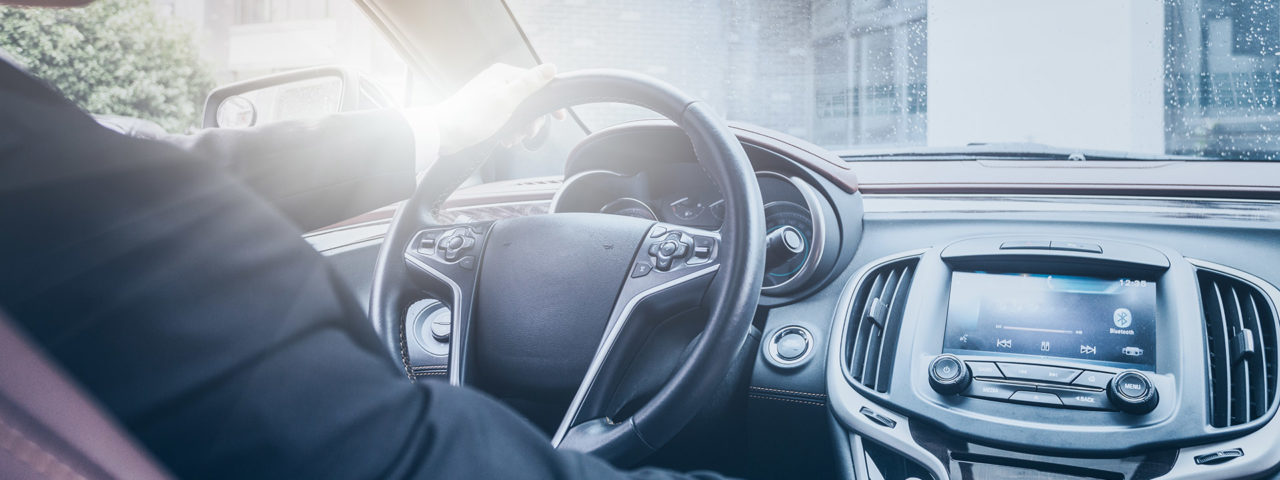detail shot of young businessman driving his car.
